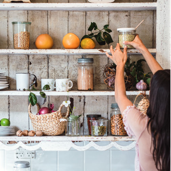 Woman reaching for food on a shelf 