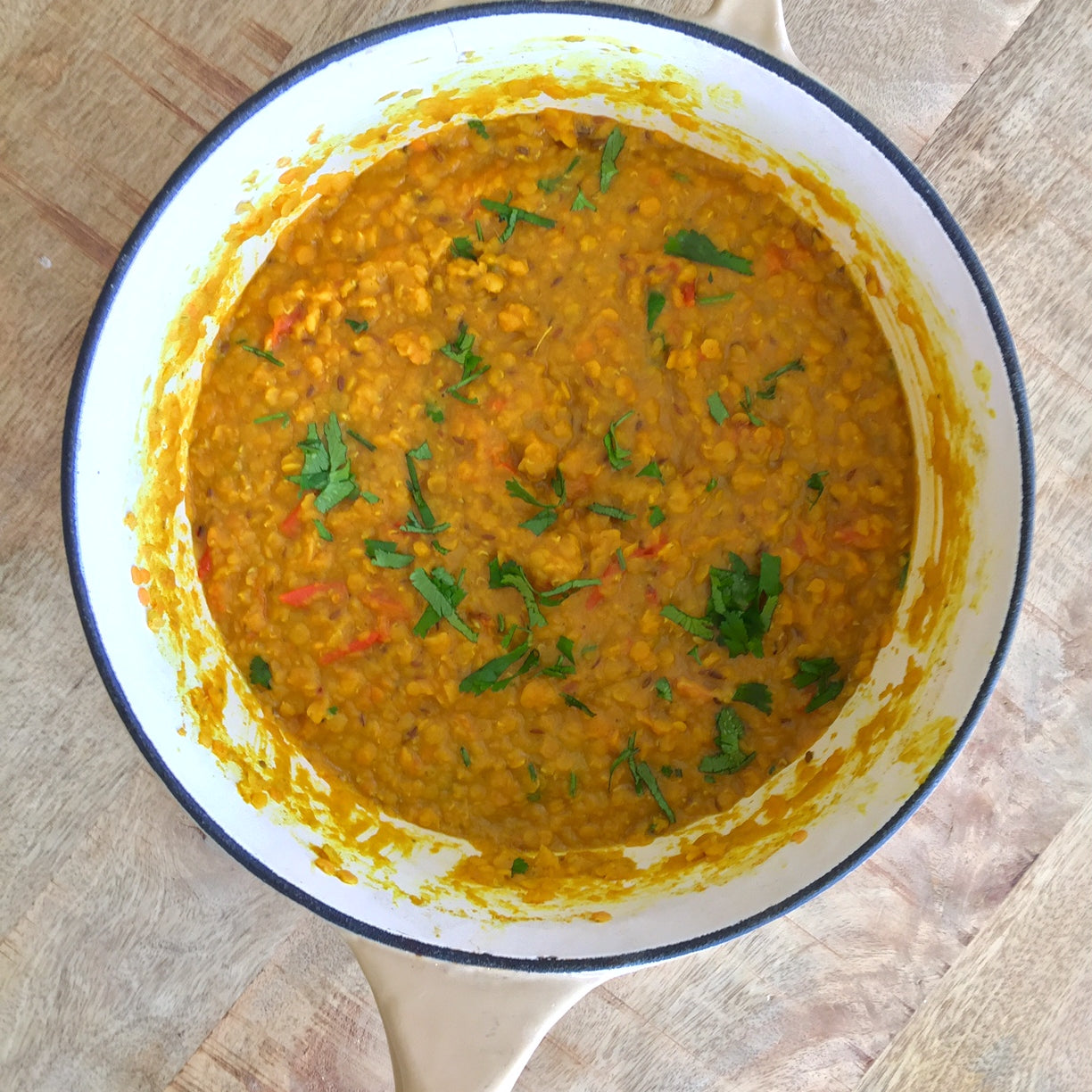 A pan containing Golden Gut Dahl curry and various veggies.