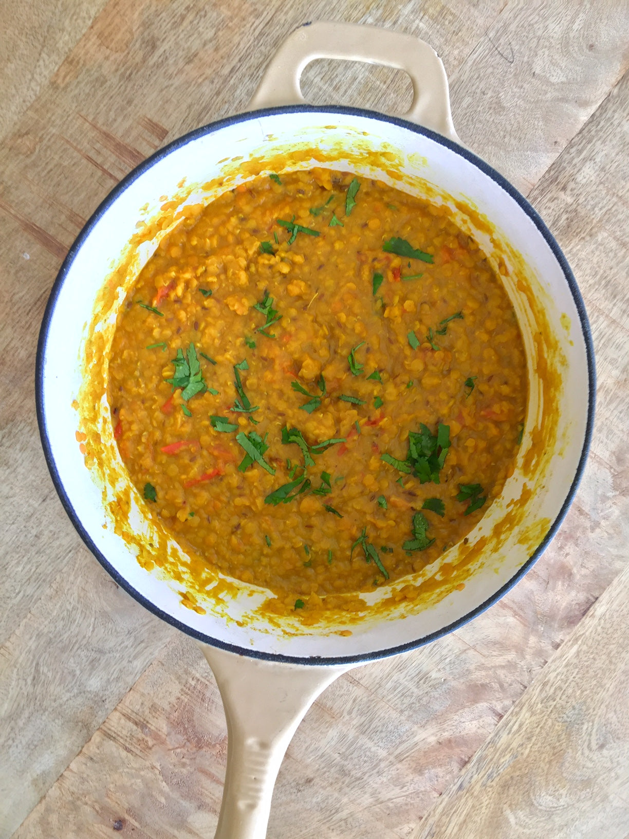 A pan containing Golden Gut Dahl curry and various veggies.
