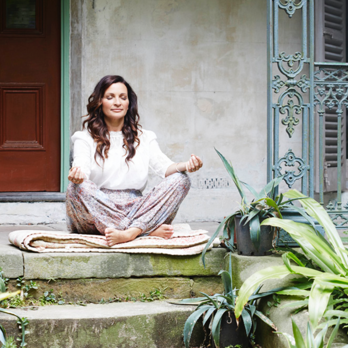 A woman sitting on the steps of a house
