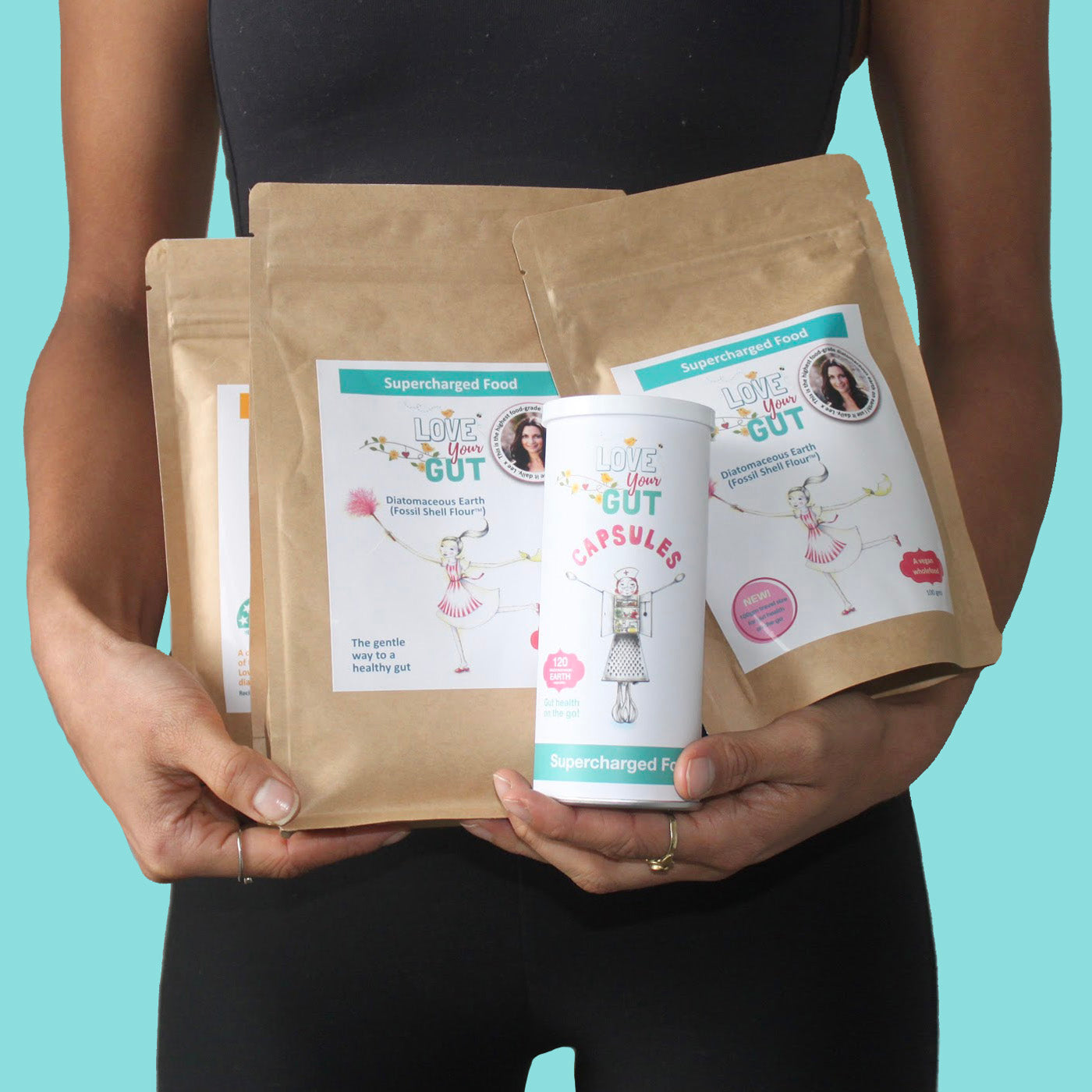 A woman holds three different types of products, promoting 'Heal Your Gut'.