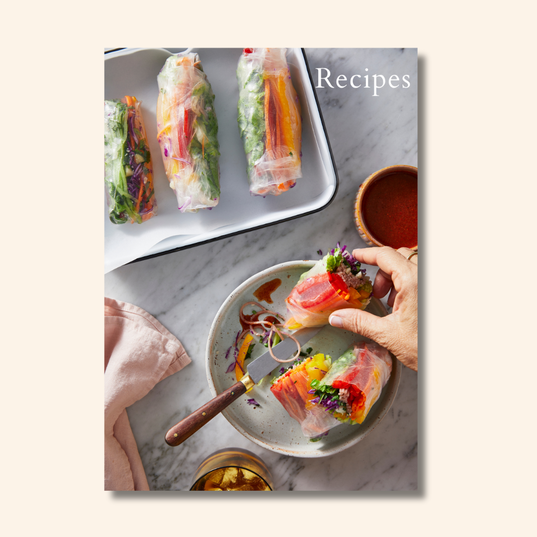 Close up of hand holding a fresh rice paper roll from the Microbiome Magazine recipes page